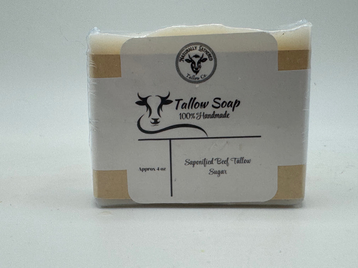 Tallow soap bar with a label on a white background