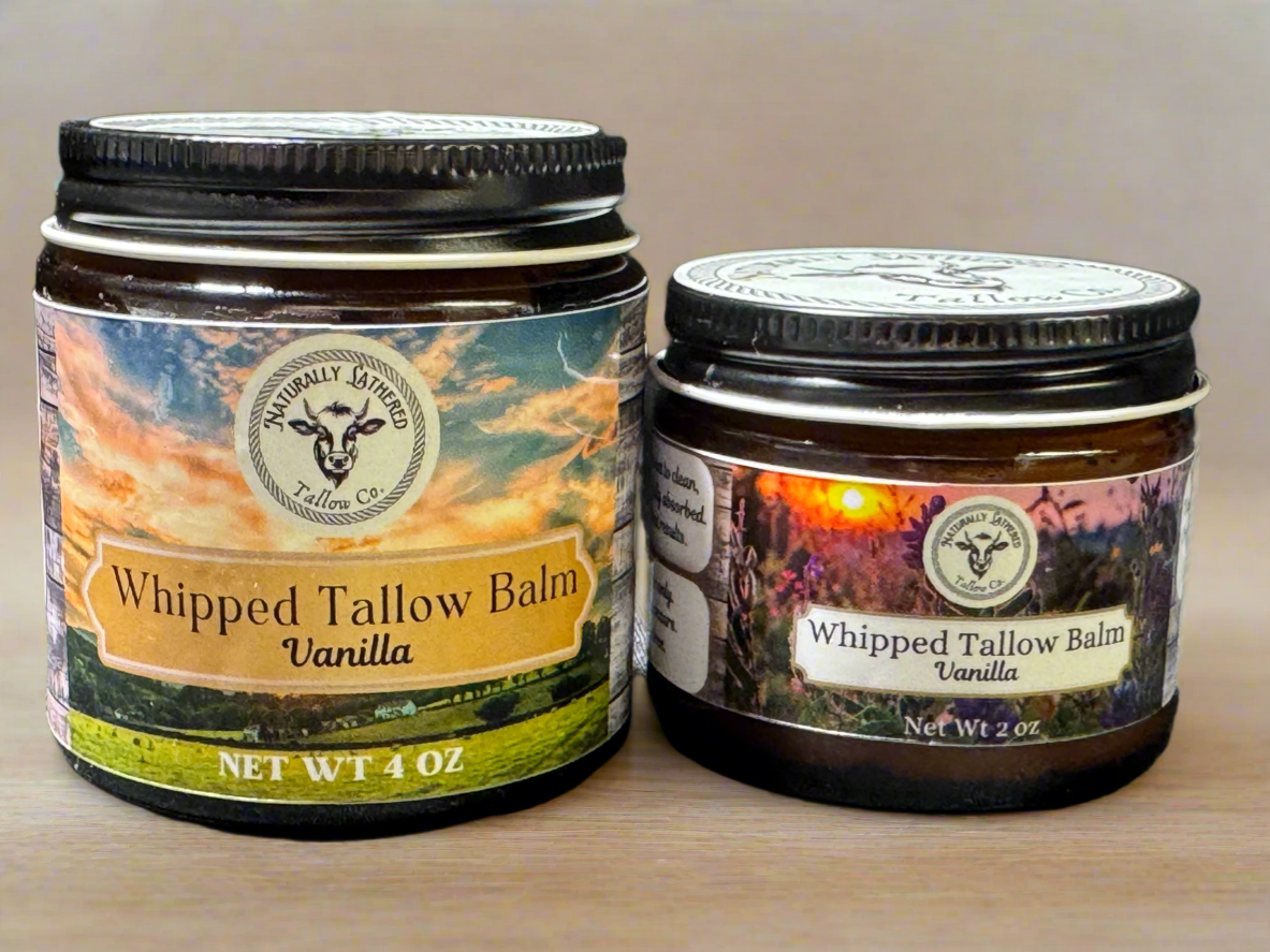 Two jars of Whipped Tallow Balm with vanilla, one larger and one smaller, with labels showing a sunset and the product name respectively.