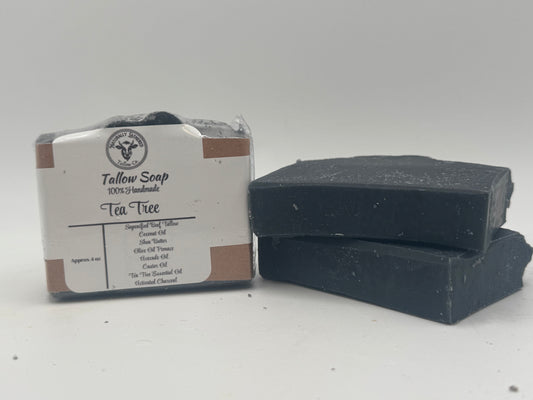 Two bars of black soap with a label on a white background