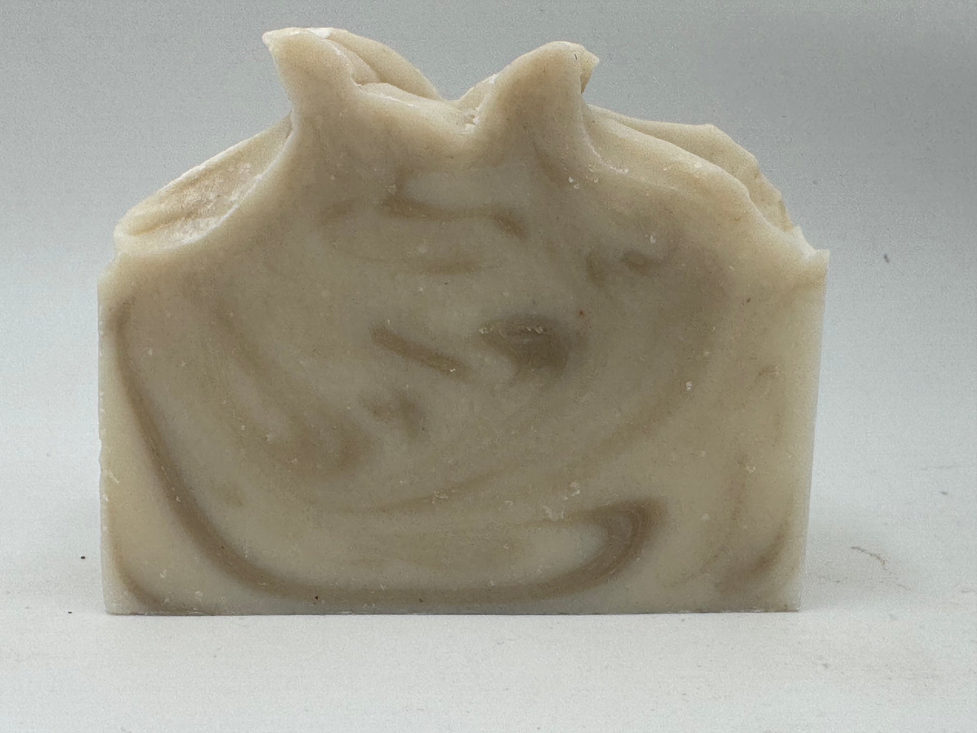 Bar of soap with a swirling pattern on a white background