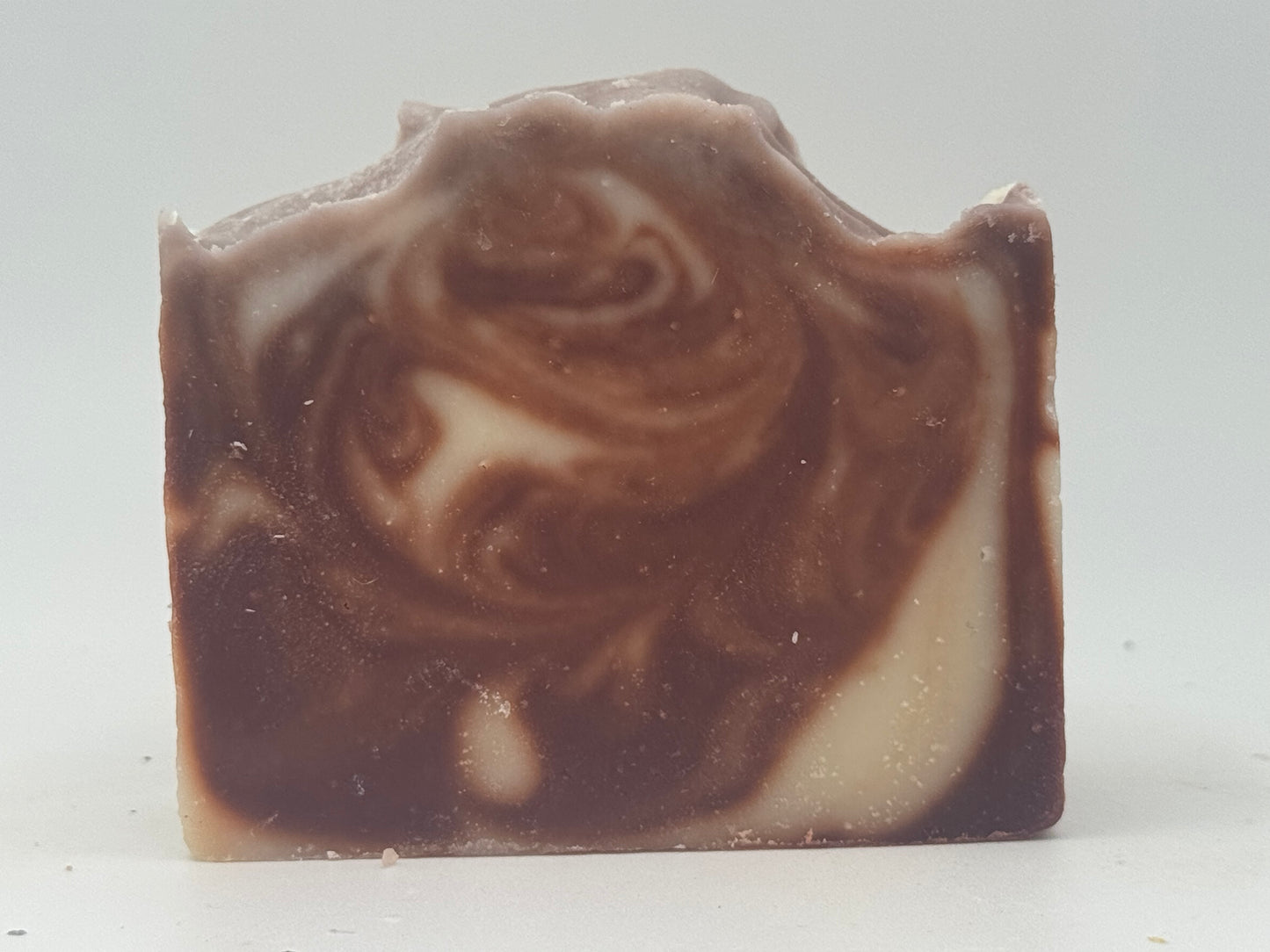 Marbled brown and beige soap bar on a white background