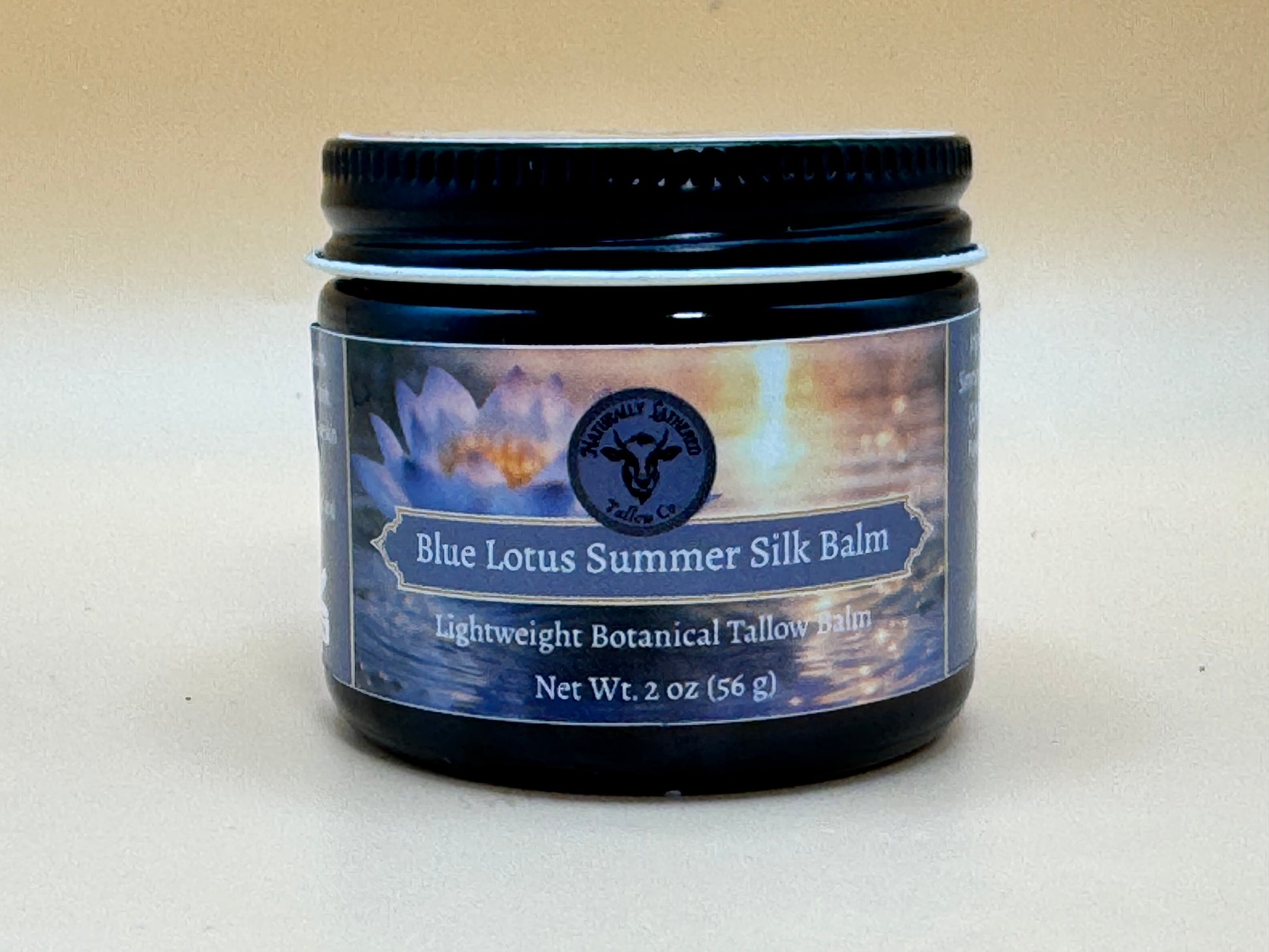Jar of Blue Lotus Summer Silk Balm with a label on a beige background