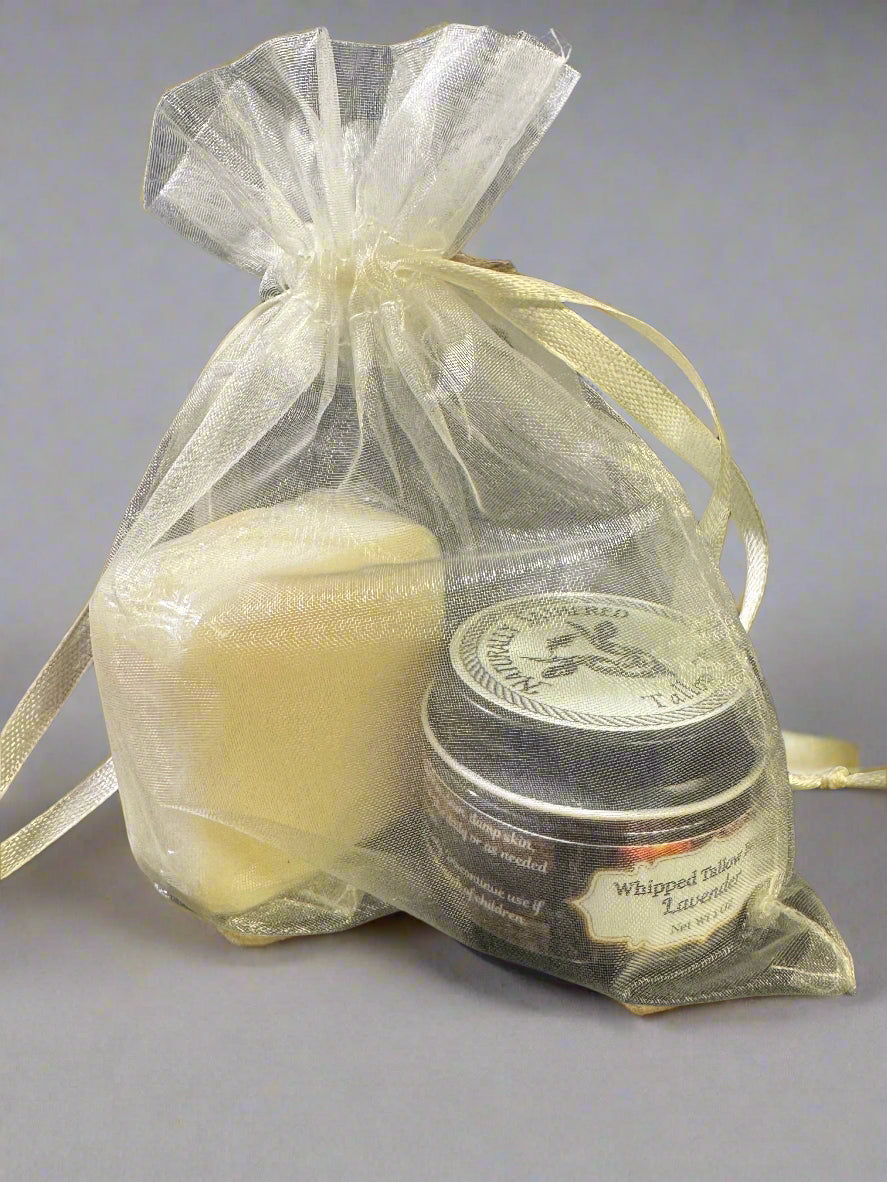 The image displays several clear organza bags with drawstrings, each containing different items including a white bar of soap and jars of balm. They are tied with beige ribbons, presenting a neat and appealing appearance.