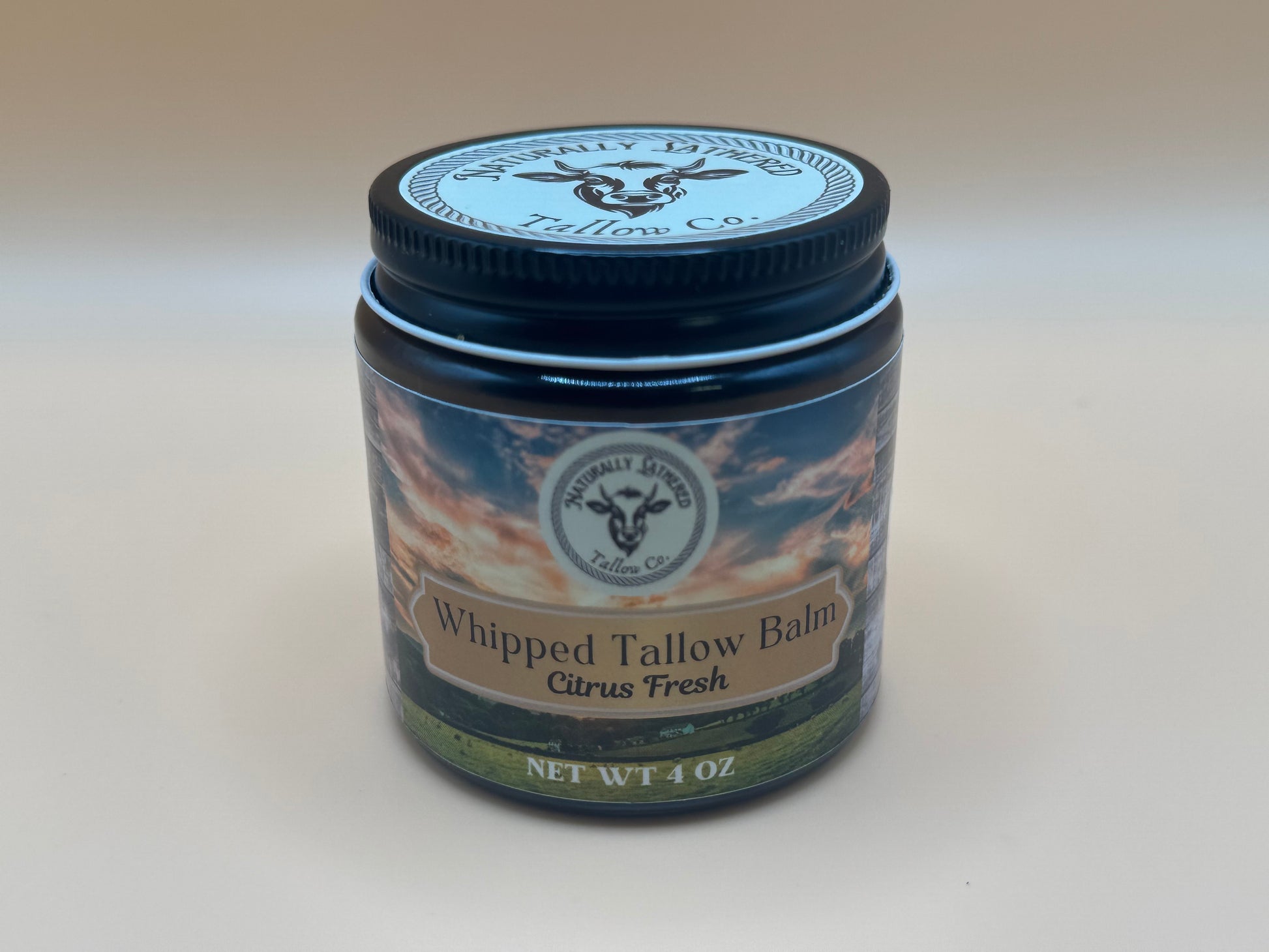 Jar of Whipped Tallow Balm with a visible brand logo on a plain background