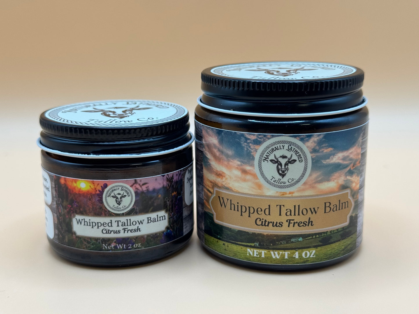 Two jars of Whipped Tallow Balm with labels on a beige background