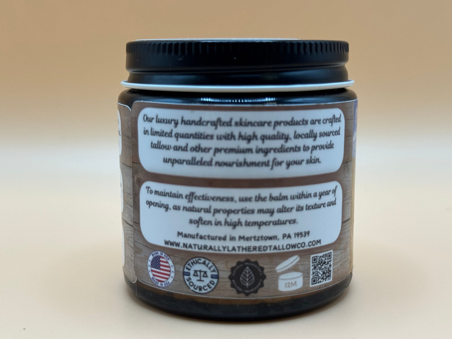 Skincare product jar with label on a beige background