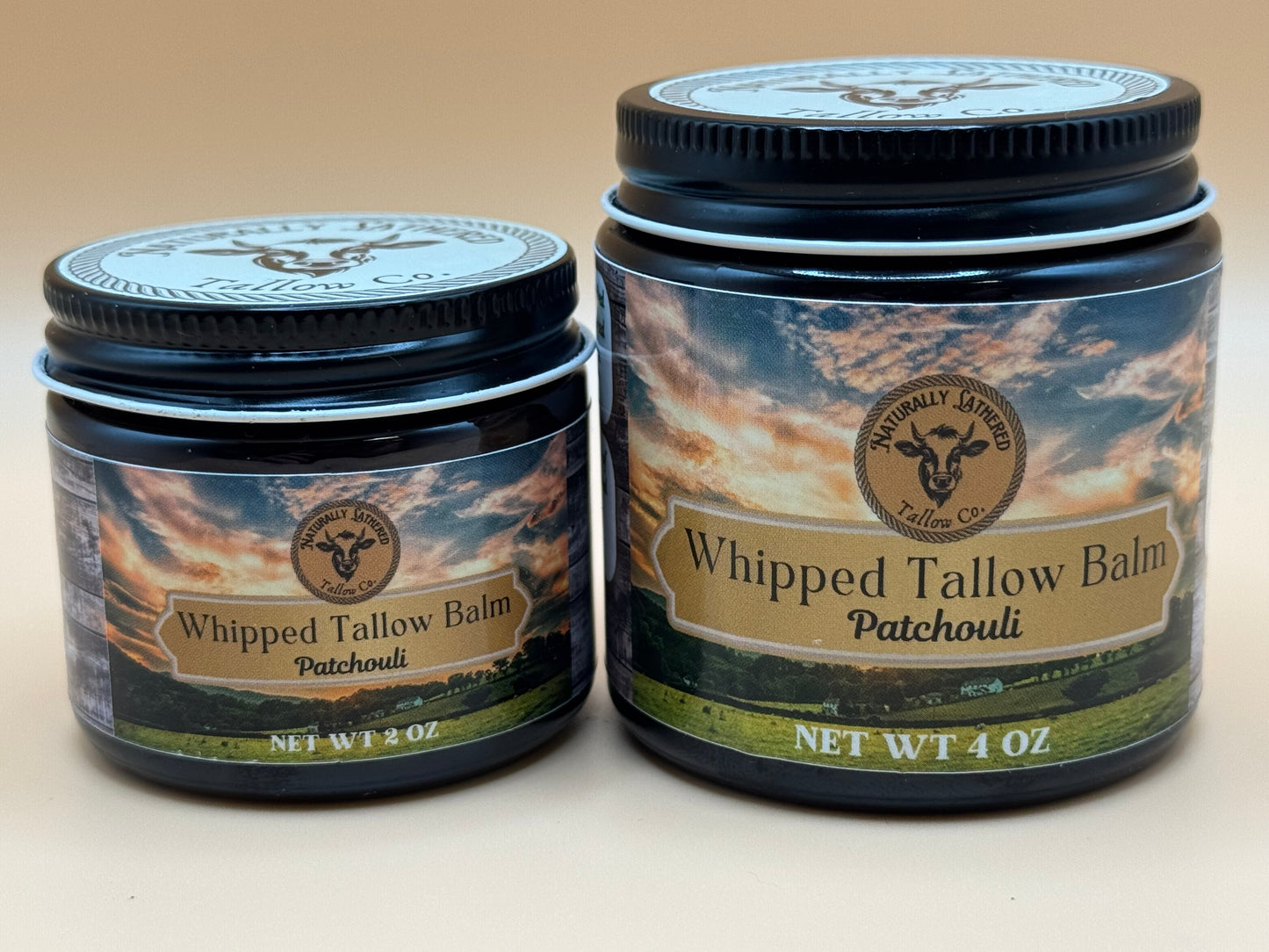 Two jars of Whipped Tallow Balm with a patchouli scent on a beige background
