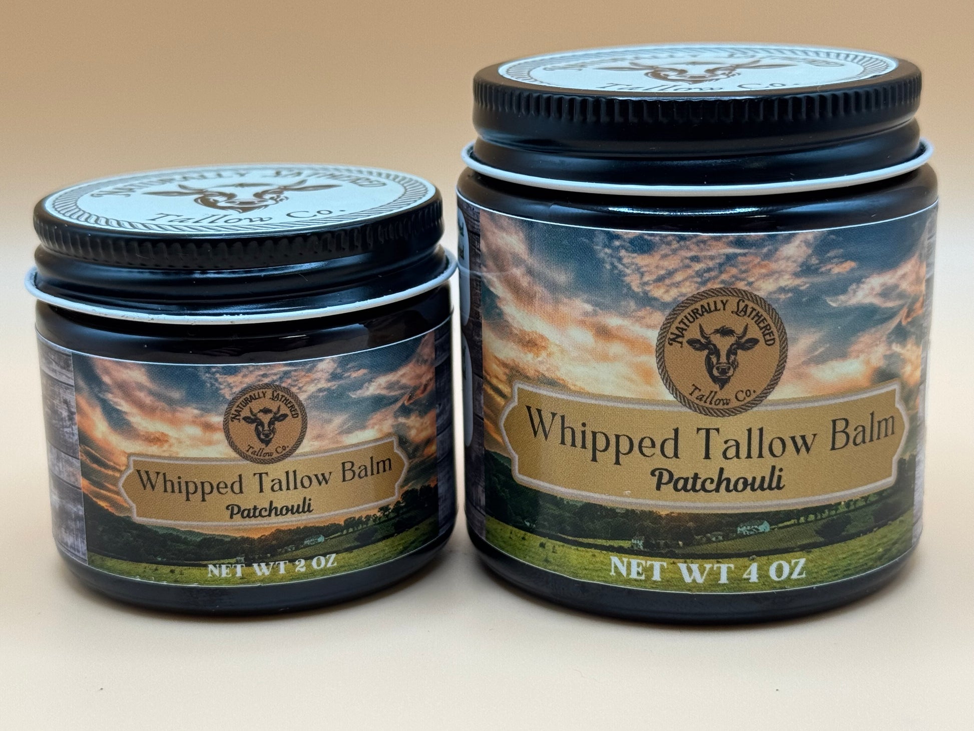 Two jars of Whipped Tallow Balm with a patchouli scent on a beige background