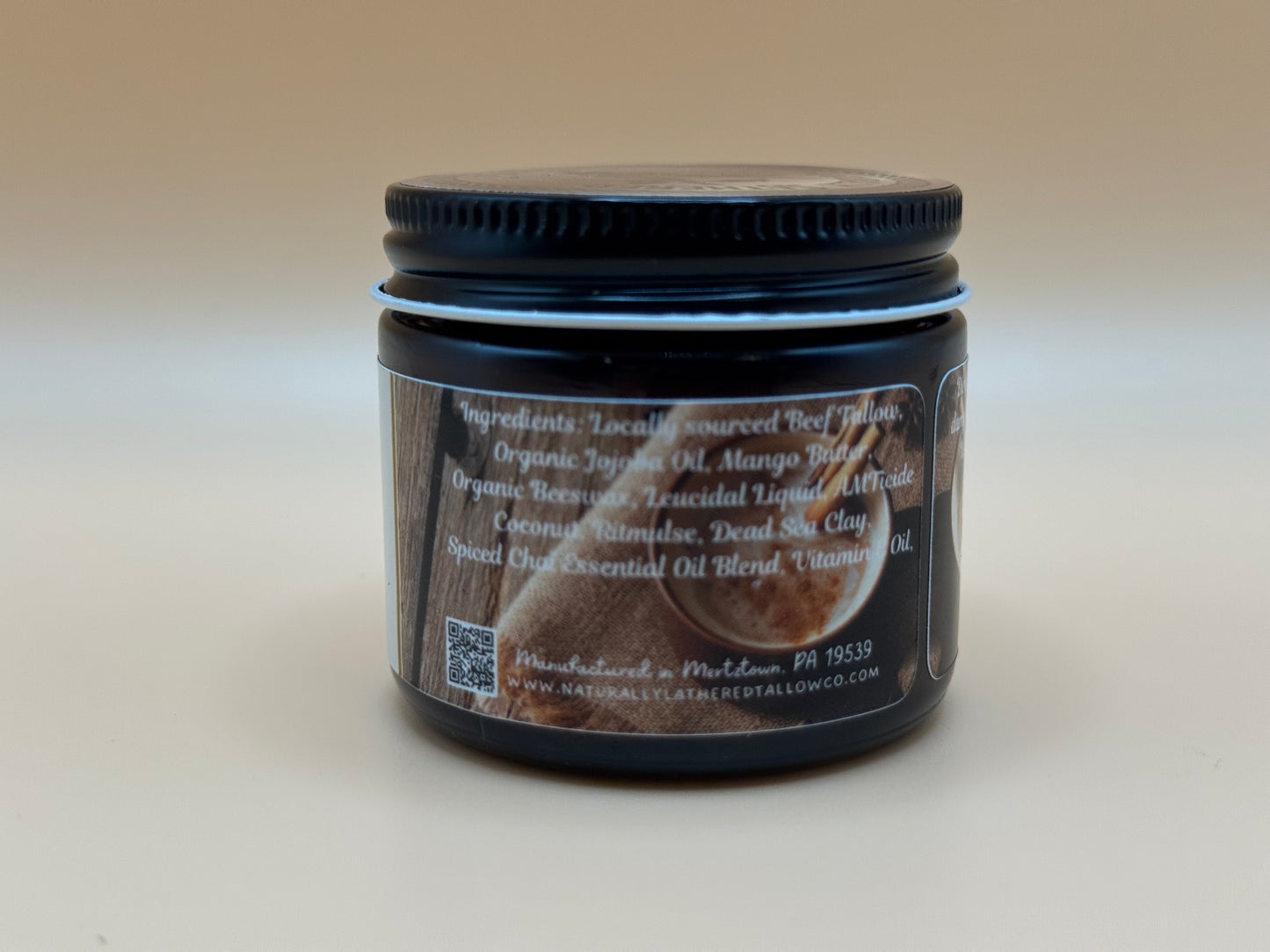 Jar with a black lid and label on a light gray background