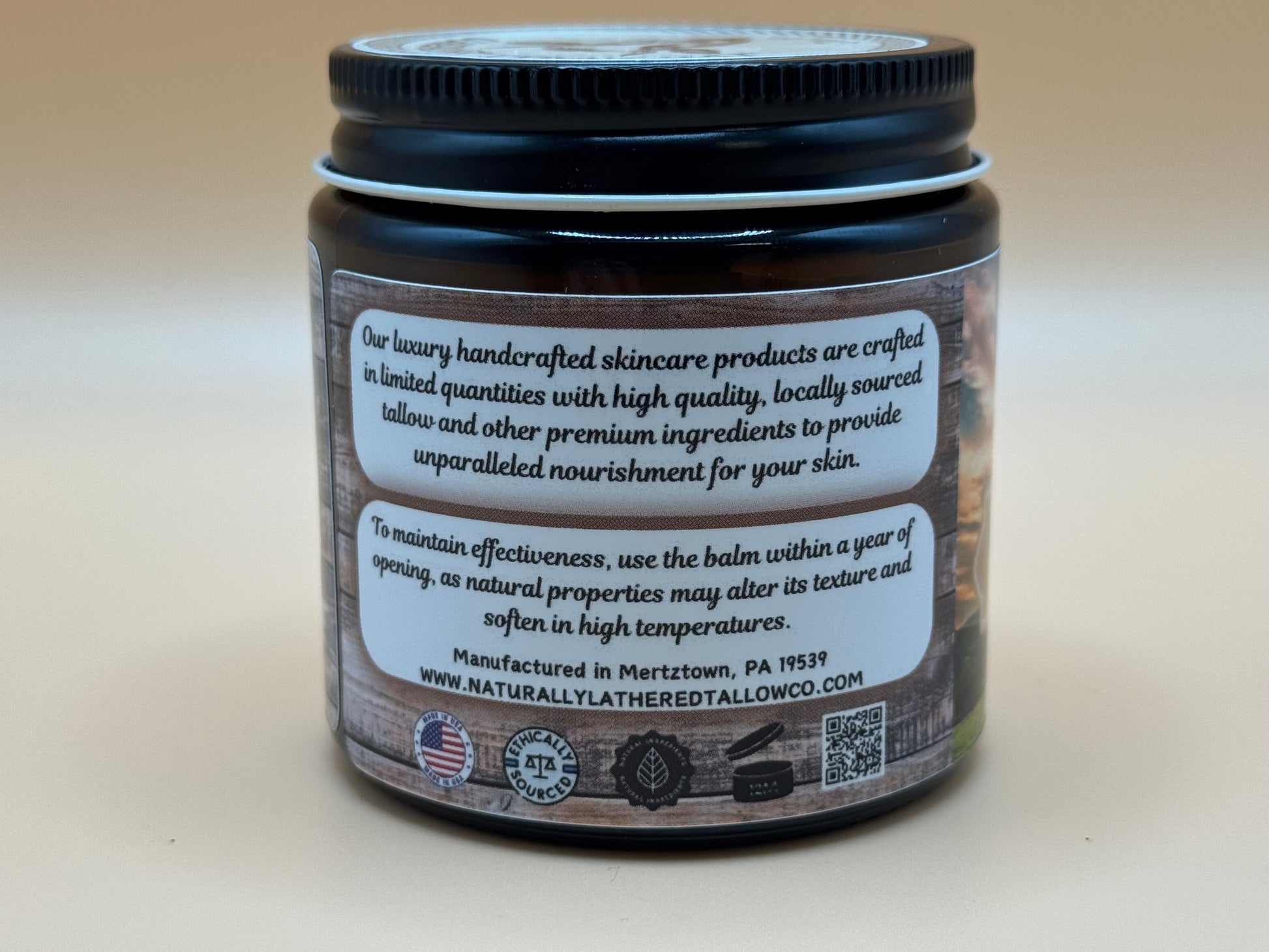 Jar of skincare product with a black lid and white label on a beige background