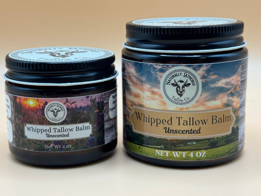 Two jars of Whipped Tallow Balm with labels on a beige background