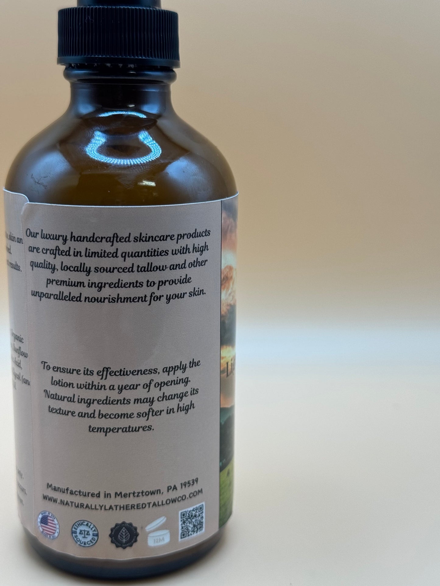 Bottle of skincare product with label on a beige background